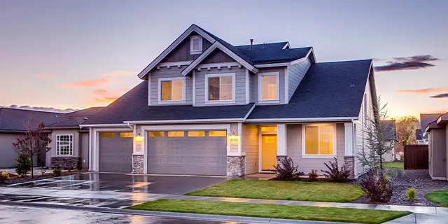 A two-story home at dusk on a landscaped lot, the kind of ordinary parcel whose minerals may have been severed by a deed reservation long before the current owner bought it